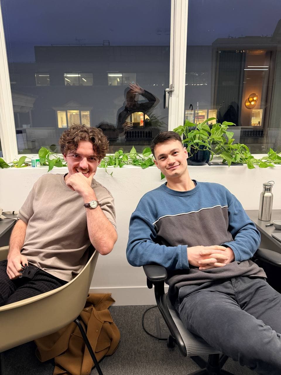 Akito seated with a collaborator in an office